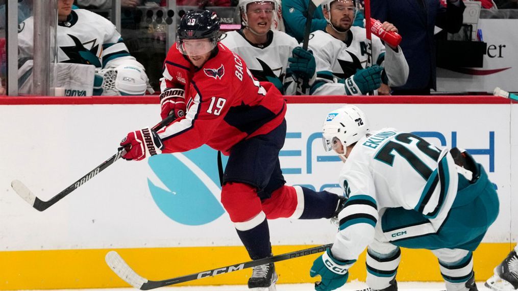 Washington Capitals center Nicklas Backstrom (19) passes the puck around San Jose Sharks center William Eklund (72) in the second period of an NHL hockey game, Sunday, Oct. 29, 2023, in Washington. (AP Photo/Mark Schiefelbein)