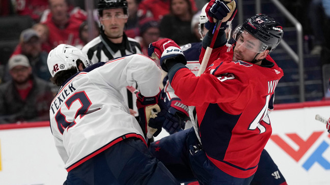 Washington Capitals right wing Tom Wilson (43) right, gets caught up with Columbus Blue Jackets center Alexandre Texier (42) during the first period of an NHL hockey game in Washington, Saturday, Nov. 18, 2023. (AP Photo/Susan Walsh)