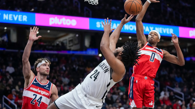 Brooklyn Nets guard Cam Thomas (24) shoots between Washington Wizards forward Corey Kispert (24) and guard Bilal Coulibaly (0) during the first half of an NBA basketball game Friday, Dec. 29, 2023, in Washington. (AP Photo/Alex Brandon)